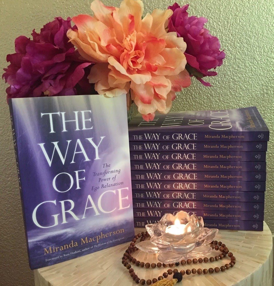 A stack of Miranda's book: The way of grace. Beautiful bouquet of pink flowers